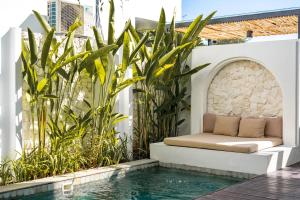 a bed sits on a patio next to a swimming pool at Villa Scorpia 1 Bingin in Bingin Beach