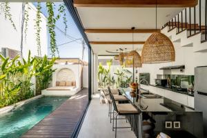 an outdoor kitchen and swimming pool in a house at Villa Scorpia 1 Bingin in Bingin Beach