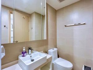 a bathroom with a sink and a toilet and a mirror at The Song Boutique Apartment in Vung Tau +95 photos