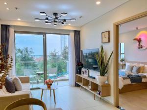 a bedroom with a bed and a large mirror at The Song Boutique Apartment in Vung Tau