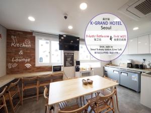 a kitchen and dining room with a table and chairs at K-Grand Hotel Seoul in Seoul