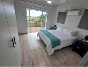 a bedroom with a bed and a sliding glass door at Beautiful Lagoon House in Blythedale
