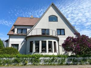 a white house with a fence in front of it at Seedri Guesthouse in Pärnu