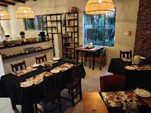 a dining room with two tables and chairs and shelves at Nylstroom Guesthouse in Modimolle