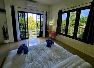 a bedroom with two blue elephants on a bed at Suwaree Garden in Koh Samui