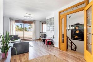 a living room with a couch and a table at Marenostrum Villa in Valencia