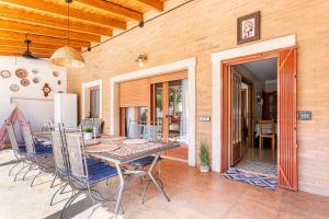 a dining room with a table and chairs on a patio at Marenostrum Villa in Valencia