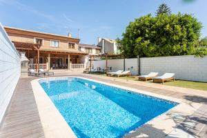 a swimming pool in the backyard of a house at Marenostrum Villa in Valencia