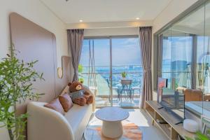 a living room with a teddy bear sitting on a couch at The Song Boutique Apartment in Vung Tau