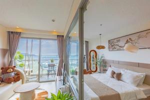 a bedroom with a bed and a balcony at The Song Boutique Apartment in Vung Tau
