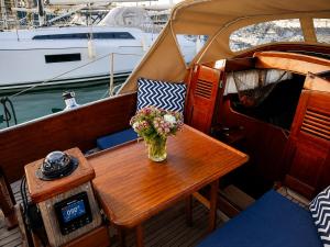 a vase of flowers on a table on a boat at Garuda yacht in Nida
