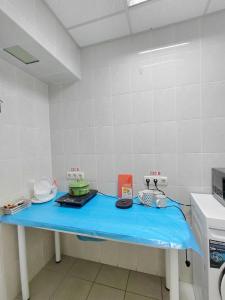 a kitchen with a blue table in a room at Tik-Tak Mini-Hotel in Cherkasy
