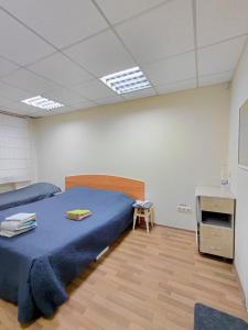 a bedroom with a bed and a table in it at Tik-Tak Mini-Hotel in Cherkasy