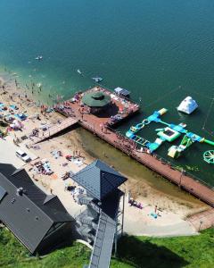 an aerial view of a beach with a pier at Domek na Szczycie u Basi in Udryń +2 photos