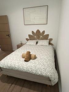 a bedroom with a bed with two pillows on it at Chambre privée in Vénissieux