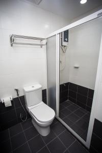 a bathroom with a toilet and a shower at Akar Hotel Jalan TAR in Kuala Lumpur