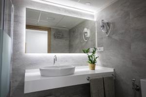 a bathroom with a sink and a mirror at Hostal Cervantes Playa in Garrucha +38 photos