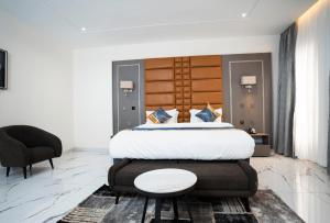 a bedroom with a large bed with a table on it at Oxvera Hotel Limited in Umuahia