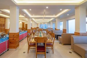 a dining room with a long table and chairs at Treebo Fagu Peaks in Shimla