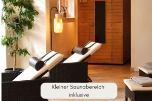 a room with two chairs and a sign that reads kier summers inclusive at Hotel Filser in Füssen