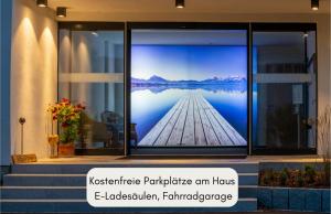 a room with a picture of a lake on the wall at Hotel Filser in Füssen