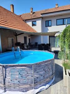 a large swimming pool in front of a house at Apartment u Ježků in Sebranice