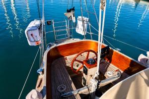 a boat is docked in the water at Garuda yacht in Nida +11 photos