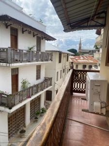 a balcony with a view of a building at Hello Rafiki Stone town in Zanzibar City