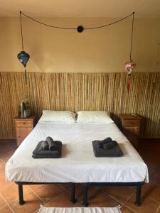 a bedroom with a bed with two towels on it at Nùi Homestay in Monastero di Lanzo