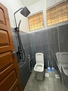 a bathroom with a toilet and a shower and a sink at Hello Rafiki Stone town in Zanzibar City +15 photos