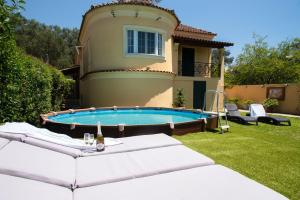 a house with a swimming pool in the yard at Eleas Gi Villa in Vitalades
