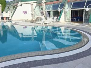 a large swimming pool in front of a building at Renovated Apartment ŽAJBELJ near Terme Topolšica in Topolšica +34 photos