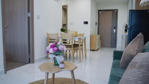 a living room with a vase of flowers on a table at 2BR-2WC-Vinhomes Grand Park-Sunset View-VincomMeGaMall-WindyHomes in Long Bình