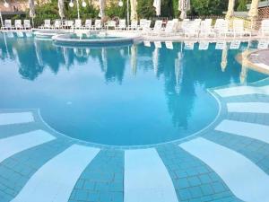 a swimming pool with blue water in a resort at Apartment DREN near terme Topolšica in Topolšica +60 photos