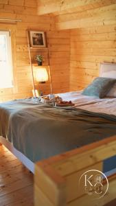 a bedroom with a bed in a log cabin at Koochill in Koczała