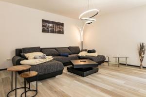 a living room with a couch and a table at Ferienwohnung Hopf in Bad Liebenstein