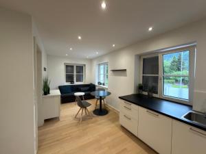 a kitchen and living room with a couch and a table at Living by Maier Altach in Altach