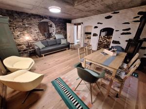 a living room with a table and chairs at Casa Piazzo Due in Brusio