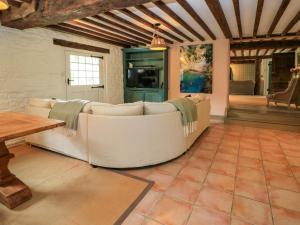 a living room with a couch and a table at The Farmhouse in Langport