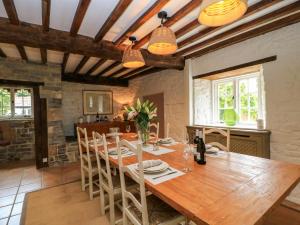 a kitchen and dining room with a wooden table and chairs at The Farmhouse in Langport
