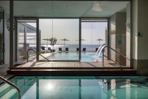 a swimming pool with a view of the ocean at Hotel Ocelle Thermae & Spa - Adults Only in Sirmione