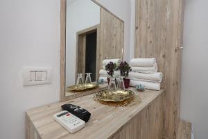 a bathroom counter with towels and a mirror at Guest House Eno in Berat +59 photos