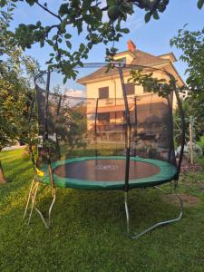a trampoline in the yard of a house at Entire Villa for 6 near Bled -Private Garden, Grill & Free Parking in Lesce
