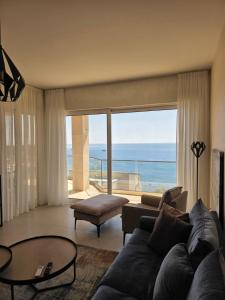 a living room with a couch and a view of the ocean at Apartments Petar in Budva