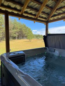 a hot tub with water in it under a cover at Koochill in Koczała
