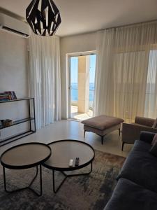 a living room with two tables and a couch at Apartments Petar in Budva