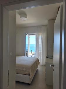 a bedroom with a bed and a view of the ocean at Apartments Petar in Budva +89 photos