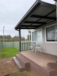 a patio with two chairs and a table on a house at Units on Robertson in Mudgee