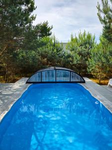 a swimming pool on the roof of a house at Dywanowy Zakątek in Sominy