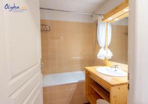 a bathroom with a sink and a bath tub at Olydea les Bottieres - Saint-Pancrace in Saint-Pancrace